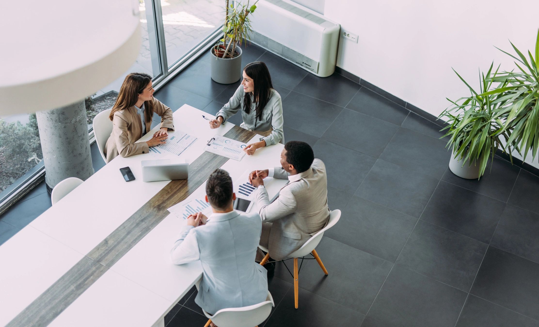 Team reviewing business plans around a conference table